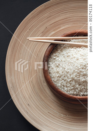 White rice in wooden bowl with wooden chopsticks White rice in wooden bowl with wooden chopsticks 80174118
