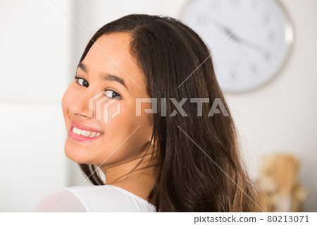 Portrait of young woman smiling at home 80213071