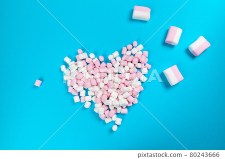 marshmallow laid out on blue paper background. pastel creative textured pattern. 80243666