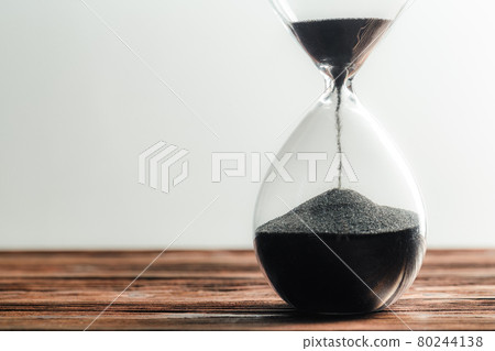 Modern hourglass on wooden background 80244138