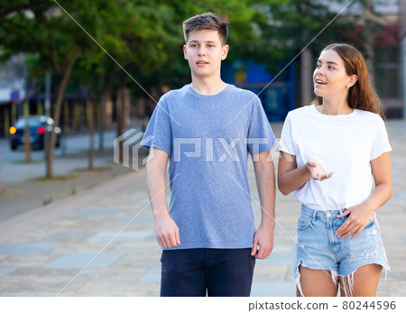 Two youngsters are walking 80244596