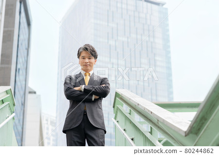 Portrait of a middle-aged businessman standing in an office building area Portrait of a middle-aged businessman standing in an office building area 80244862