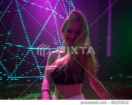 Portrait of beautiful DJ girl standing in the front of the decks. Party and holiday style.. Portrait of beautiful DJ girl standing in the front of the decks. Party and holiday style.. 80245622