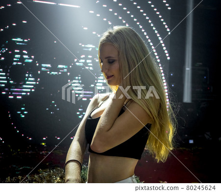 Portrait of beautiful DJ girl standing in the front of the decks. Party and holiday style.. Portrait of beautiful DJ girl standing in the front of the decks. Party and holiday style.. 80245624