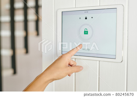 Hand of young woman pointing at display with security symbol Hand of young woman pointing at display with security symbol 80245670