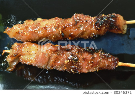 grilled pork dressings spicy sauce stabbing in wooden stick with vegetable on plate grilled pork dressings spicy sauce stabbing in wooden stick with vegetable on plate 80246371