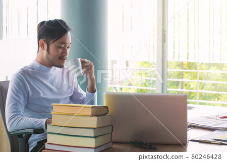 Business man working with laptop computer and documents on his desk at office Business man working with laptop computer and documents on his desk at office 80246428