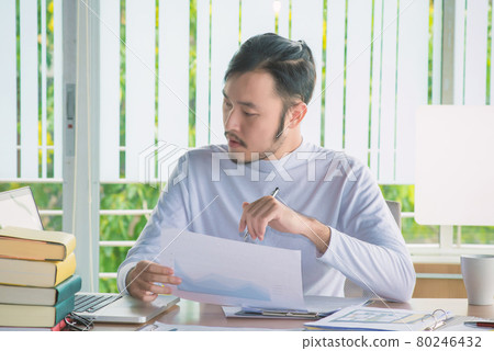 Business man working with laptop computer and documents on his desk at office 80246432