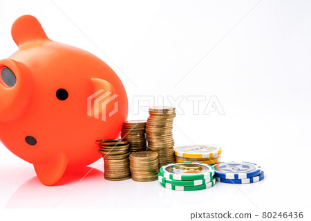 Piggy bank and money coins stack with casino chips on white background. Concept of gambling savings. Piggy bank and money coins stack with casino chips on white background. Concept of gambling savings. 80246436