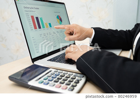Asian accountant working and analyzing financial reports project accounting with chart graph and calculator in modern office, finance and business concept. Asian accountant working and analyzing financial reports project accounting with chart graph and calculator in modern office, finance and business concept. 80246959