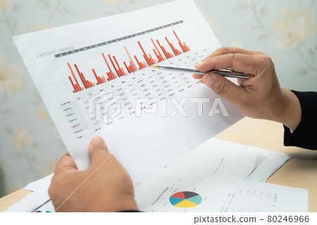 Asian accountant working and analyzing financial reports project accounting with chart graph and calculator in modern office, finance and business concept. 80246966