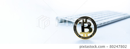 Bitcoin wallet. Golden Bit Coin virtual cryptocurrency or blockchain technology. Gold Crypto currency BTC with keyboard on white background. Investing in virtual assets, Bull market trend concept. 80247802