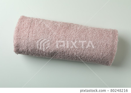 Clean rolled pink towel on white background Clean rolled pink towel on white background 80248216