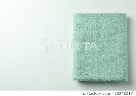 Clean green folded towel on white background Clean green folded towel on white background 80248217