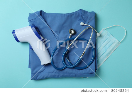 Medical tools and thermometer gun on blue background 80248264