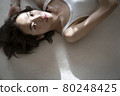 Portrait of a woman lying down 80248425
