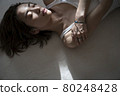Portrait of a woman lying down 80248428