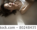 Portrait of a woman lying down 80248435