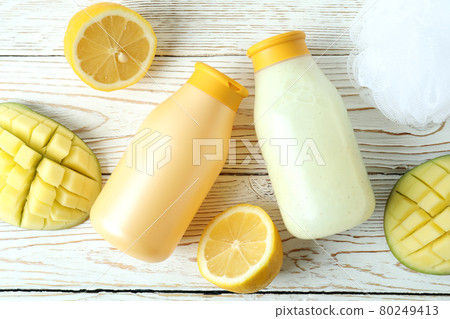 Shower gels, mango and lemon on white wooden background 80249413