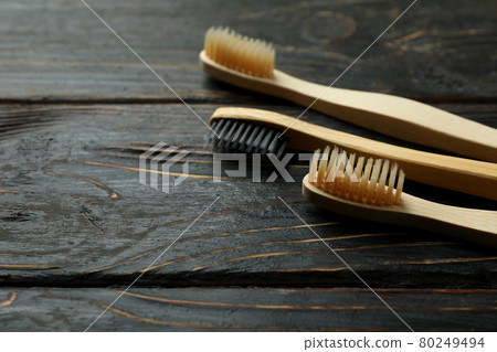 Eco friendly toothbrushes on rustic wooden background Eco friendly toothbrushes on rustic wooden background 80249494