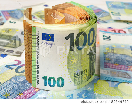 448 Roll of 100 and 50 euro paper banknotes over money background. 448 Roll of 100 and 50 euro paper banknotes over money background. 80249713