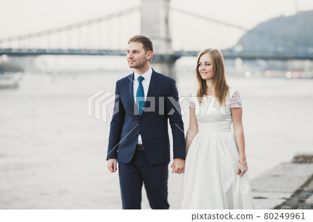 Wedding couple, groom and bride hugging, outdoor near river Wedding couple, groom and bride hugging, outdoor near river 80249961