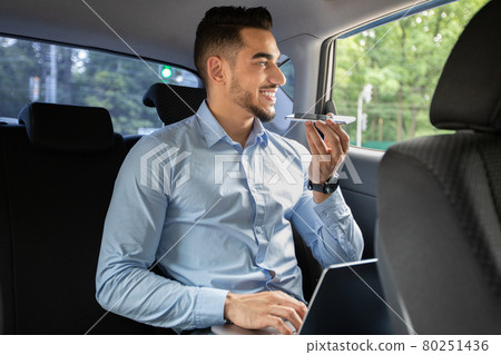 Young arab man CEO working at car back seat Young arab man CEO working at car back seat 80251436