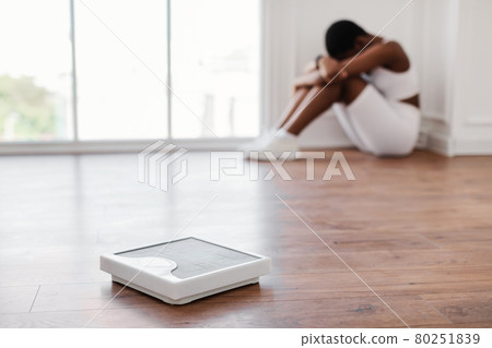 Portrait of Unhappy African Woman Crying, Focus On Scale 80251839