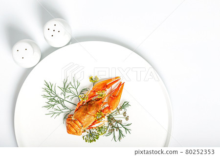 Boiled orange crayfish with dill on a white plate on a white background. Delicious crayfish with aromatic dill and spices. Blank for the menu. Organic wild food. Copy space. Top view Boiled orange crayfish with dill on a white plate on a white background. Delicious crayfish with aromatic dill and spices. Blank for the menu. Organic wild food. Copy space. Top view 80252353