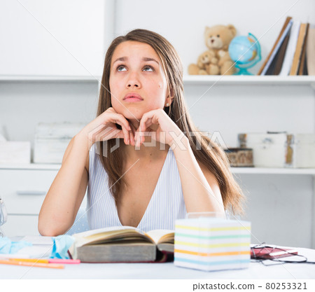 Teenage female is doing homework Teenage female is doing homework 80253321