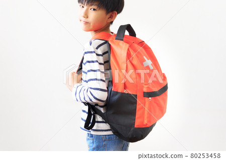 A boy carrying a disaster prevention backpack 80253458
