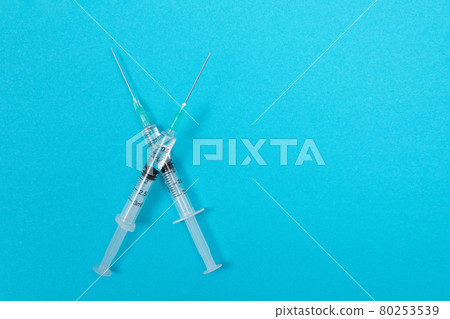 Vaccination or Revaccination Concept - Two Medical Syringe on Blue Table 80253539