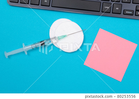 Vaccination or Revaccination Concept - A Medical Syringe on Blue Table 80253556