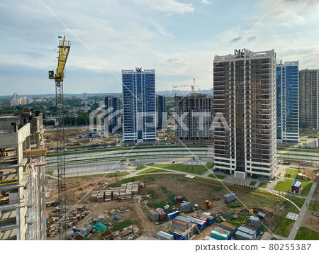 A view from a height of a large modern construction site of tall large houses and multi-storey buildings. A construction site for the development of a new microdistrict in a big city 80255387