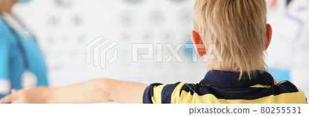 Little boy stands in the ophthalmologists office 80255531