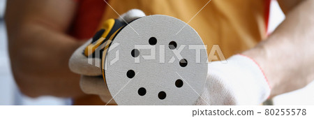 Male hands in gloves replaces spare part on sander Male hands in gloves replaces spare part on sander 80255578