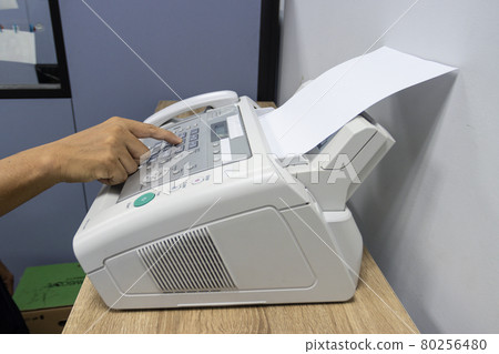 hand man are using a fax machine in the office, equipment for data transmission. 80256480