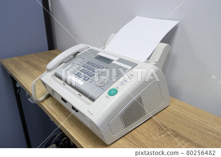 hand man are using a fax machine in the office, equipment for data transmission. 80256482