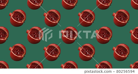 Pomegranate pattern on a green background. Summer fruit seamless pattern. Original minimal food concept. Pomegranate fruit with red shiny beads. Pop art design Pomegranate pattern on a green background. Summer fruit seamless pattern. Original minimal food concept. Pomegranate fruit with red shiny beads. Pop art design 80256594