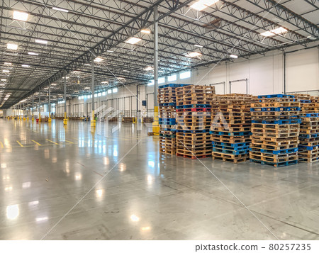 Massive Empty Industrial Warehouse Interior With Stacked Pallets 80257235