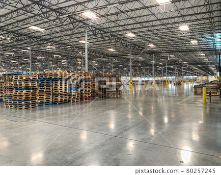 Massive Empty Industrial Warehouse Interior With Stacked Pallets 80257245