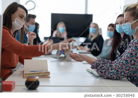 new normal businesspeople on meeting using antibacterial hand sanitizer 80258048