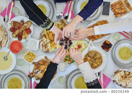Top view of muslim family having Iftar during Ramadan holy month Top view of muslim family having Iftar during Ramadan holy month 80258149