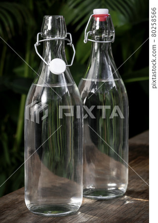 flip top clear water bottle outdoors on garden table flip top clear water bottle outdoors on garden table 80258566