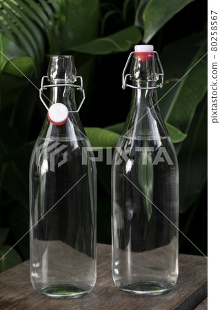 flip top clear water bottle outdoors on garden table flip top clear water bottle outdoors on garden table 80258567