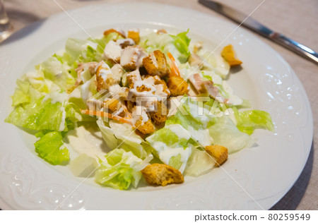 Appetizing Caesar salad with chicken breast, lettuce and toast 80259549