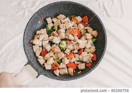 Stir fried chicken with mixed vegetables. 80260756