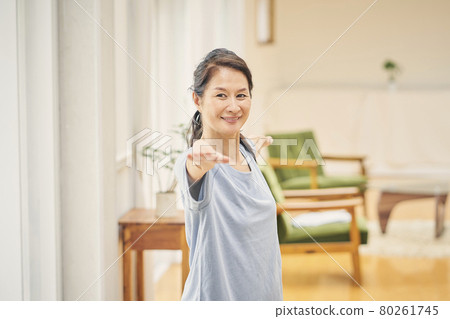 A woman doing yoga at home A woman doing yoga at home 80261745