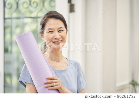 A woman doing yoga at home A woman doing yoga at home 80261752