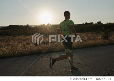 triathlon athlete running on morning trainig 80266274